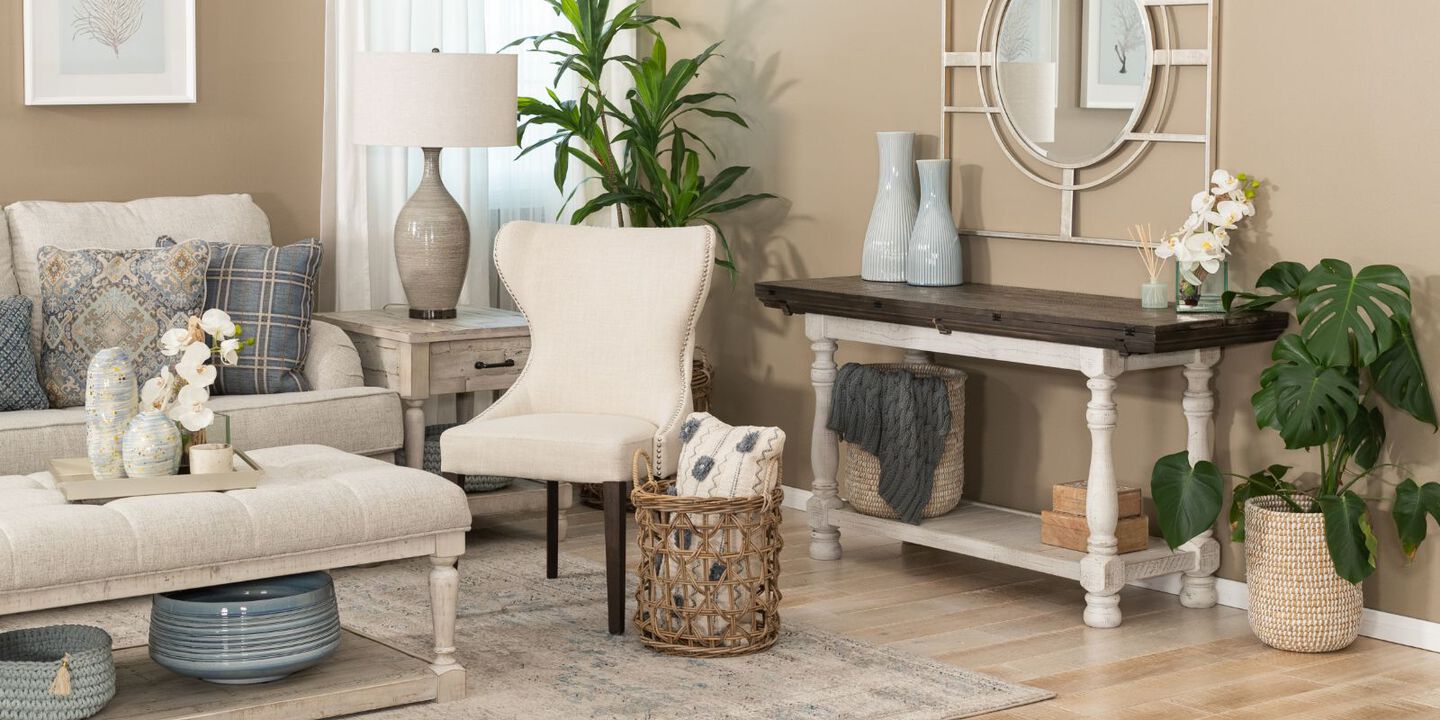 living room with upholstered coffee table and a light beige couch and chair