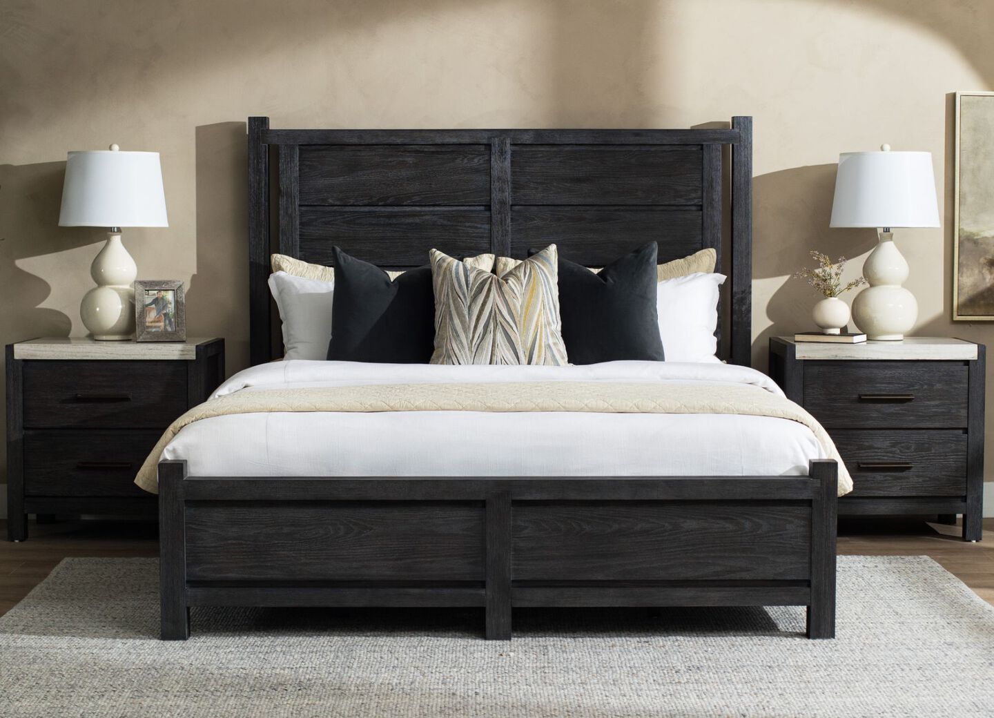 Black wooden bed with two matching nightstands sitting on either side.