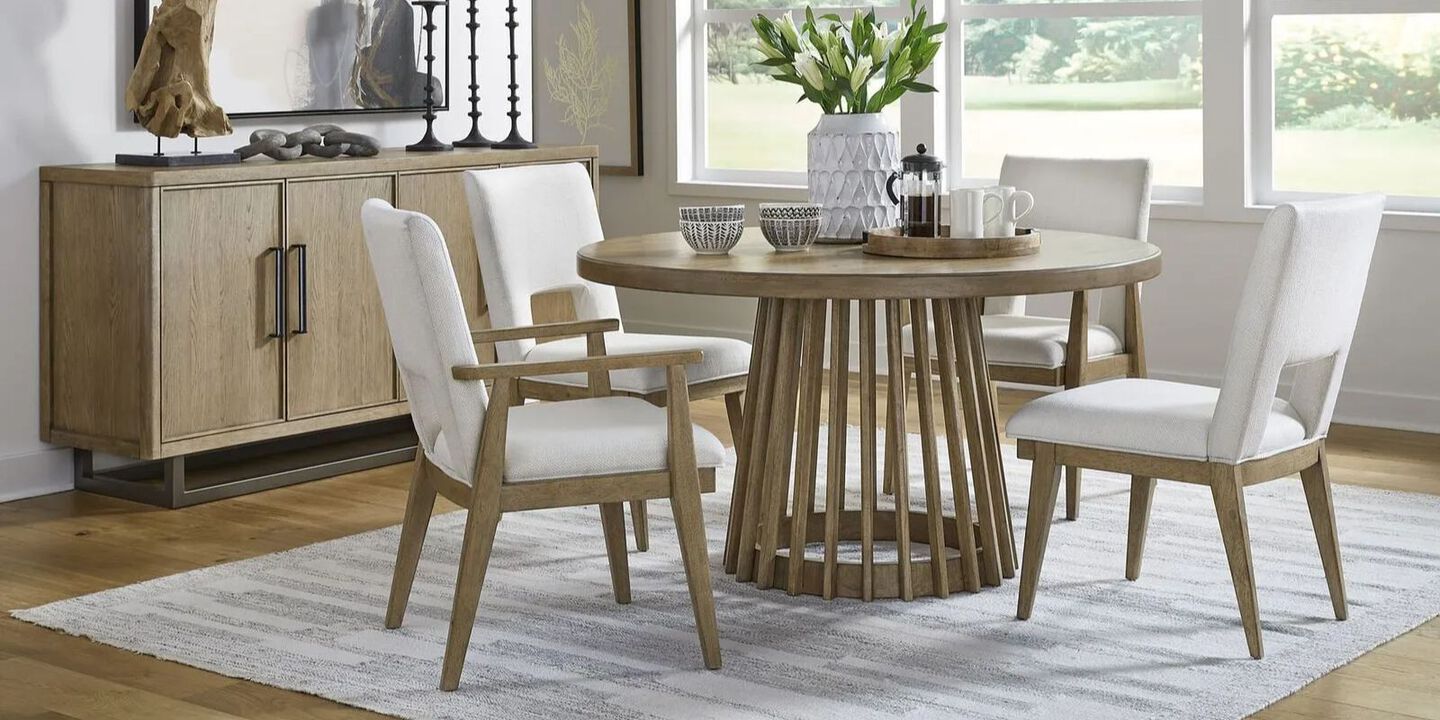 Dining room with wooden cabinet, wooden table, and four white upholstered wooden chairs