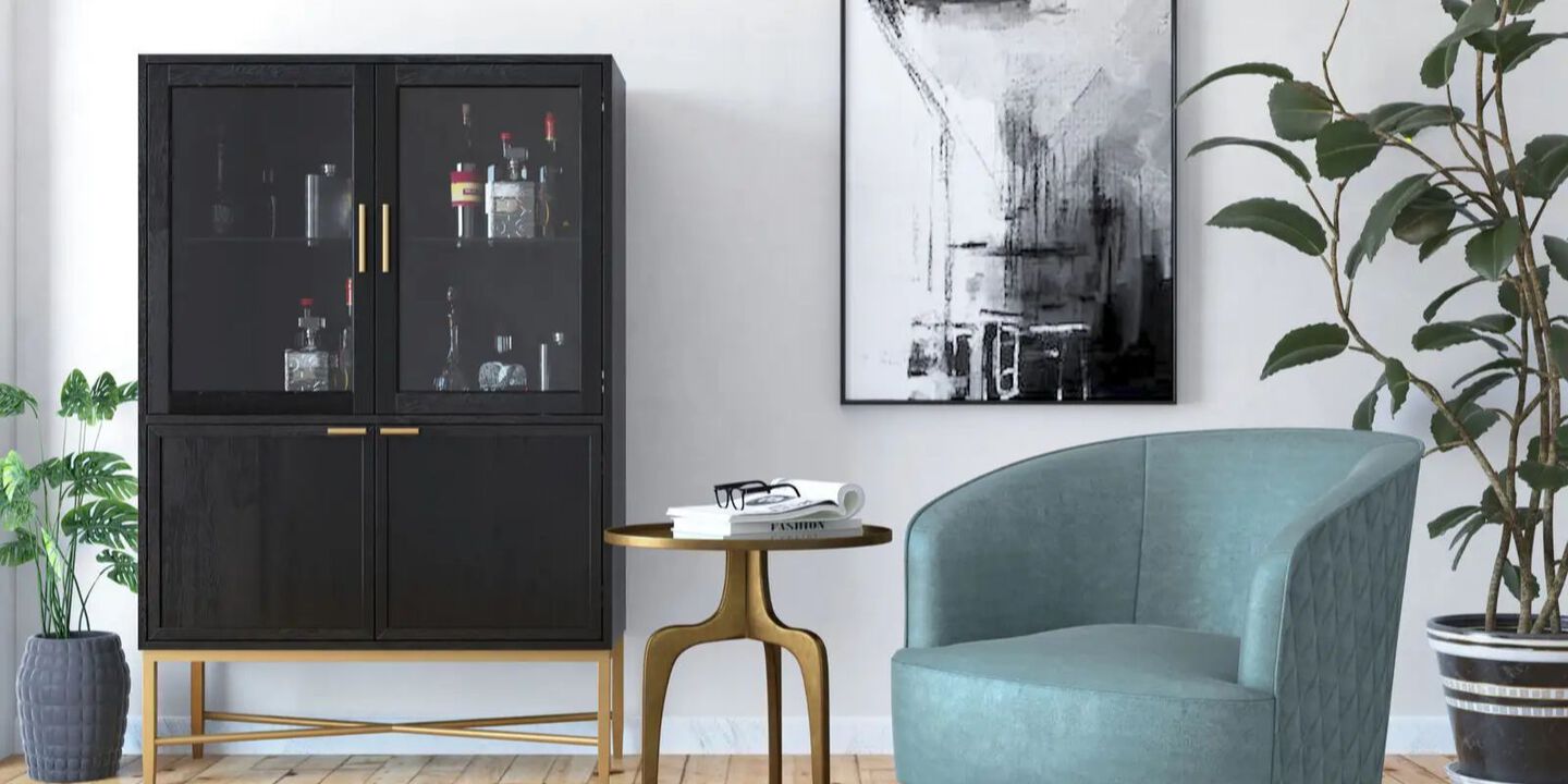 Room setting with black liquor cabinet, gold side table, and blue velvet chair