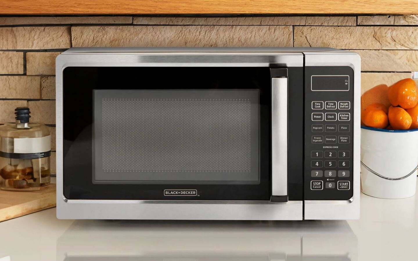 Silver and black microwave sitting on countertop