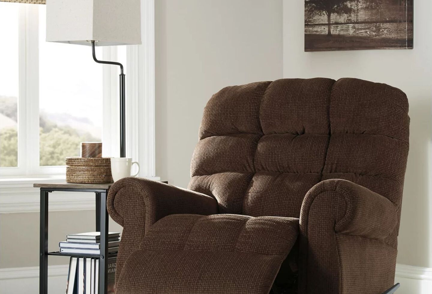 Dark brown recliner with brown and black side table and lamp
