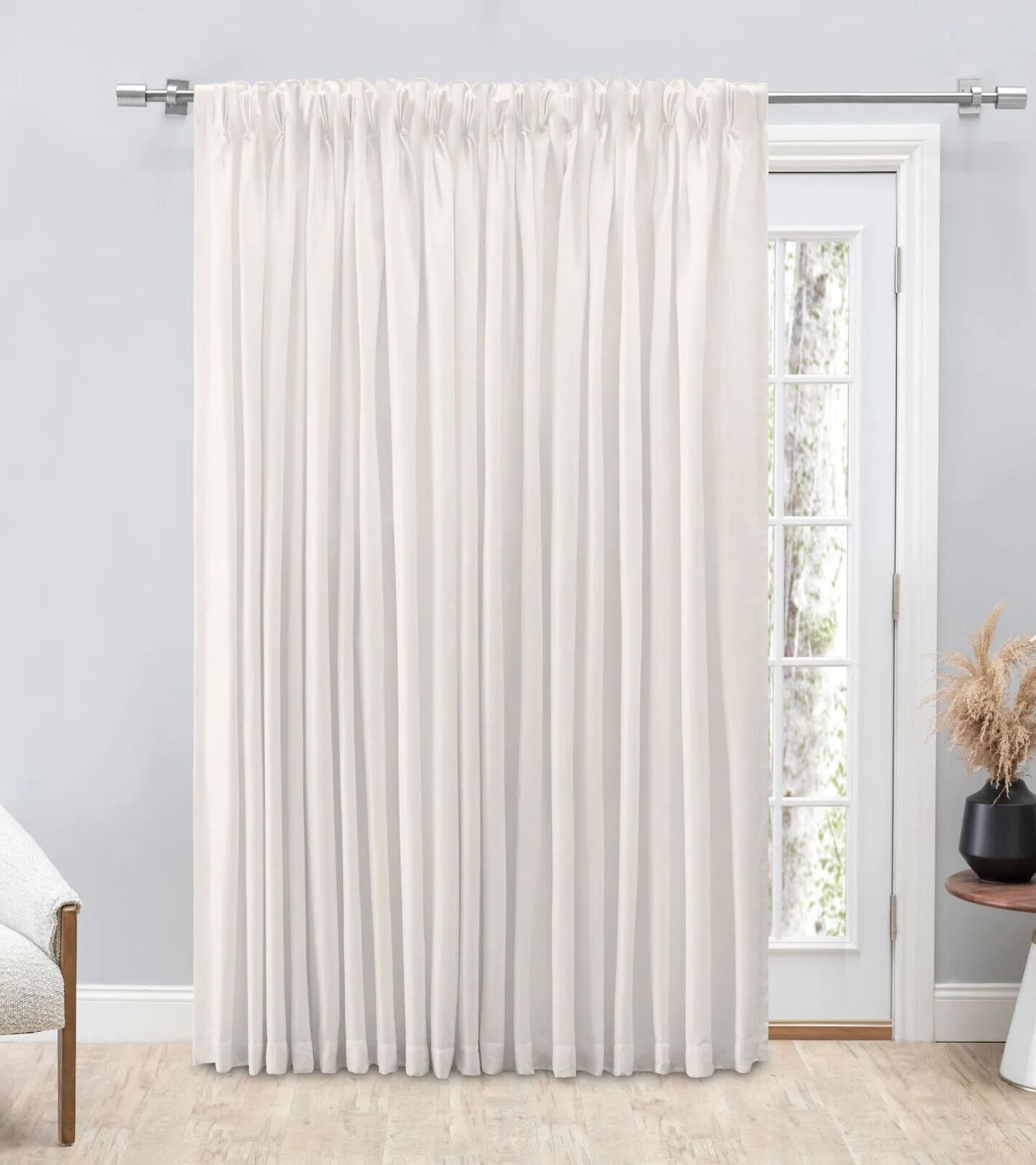 large white paneled window with white floor length curtains