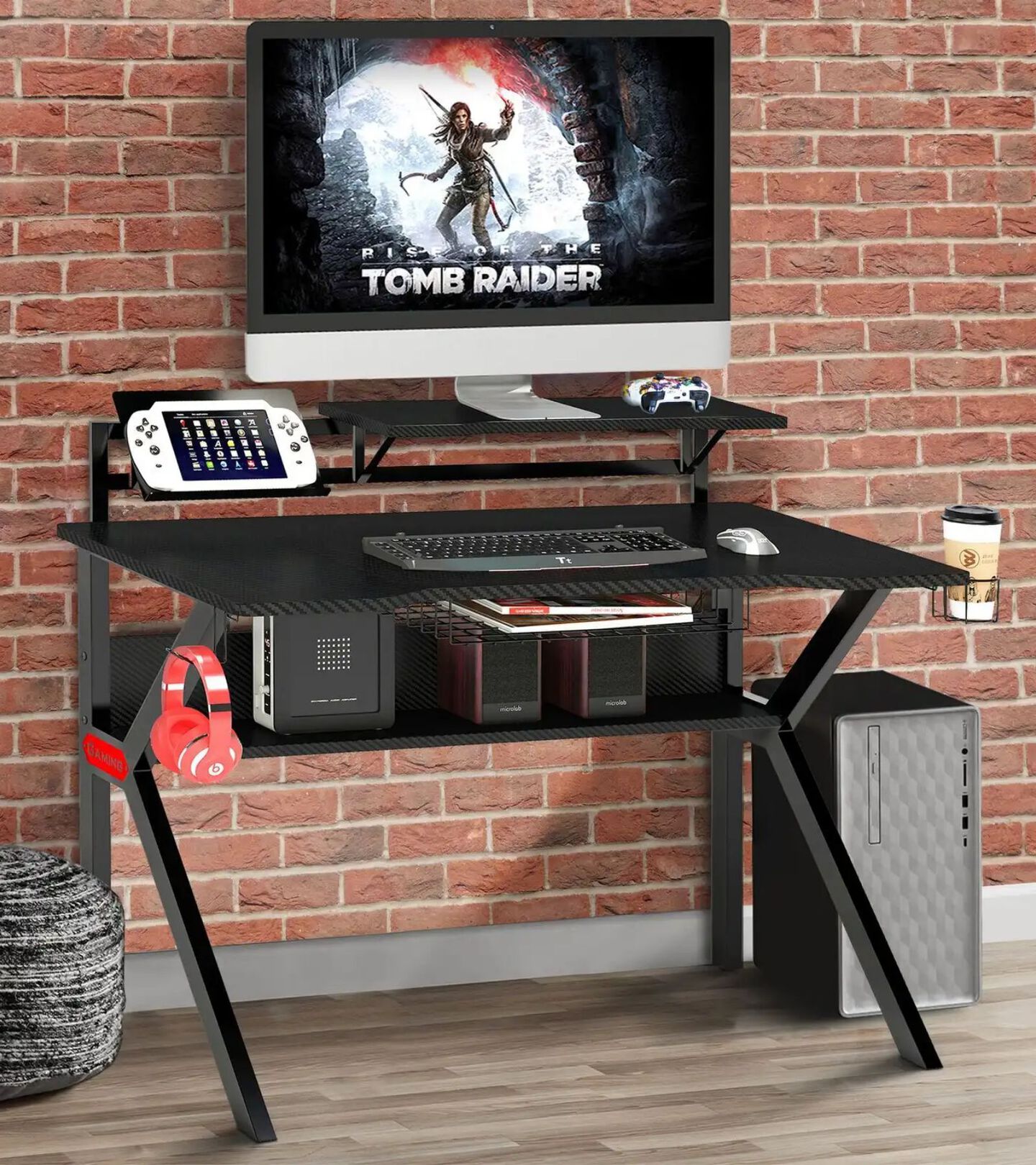 gaming setup with a black stand, speakers, and computer monitor