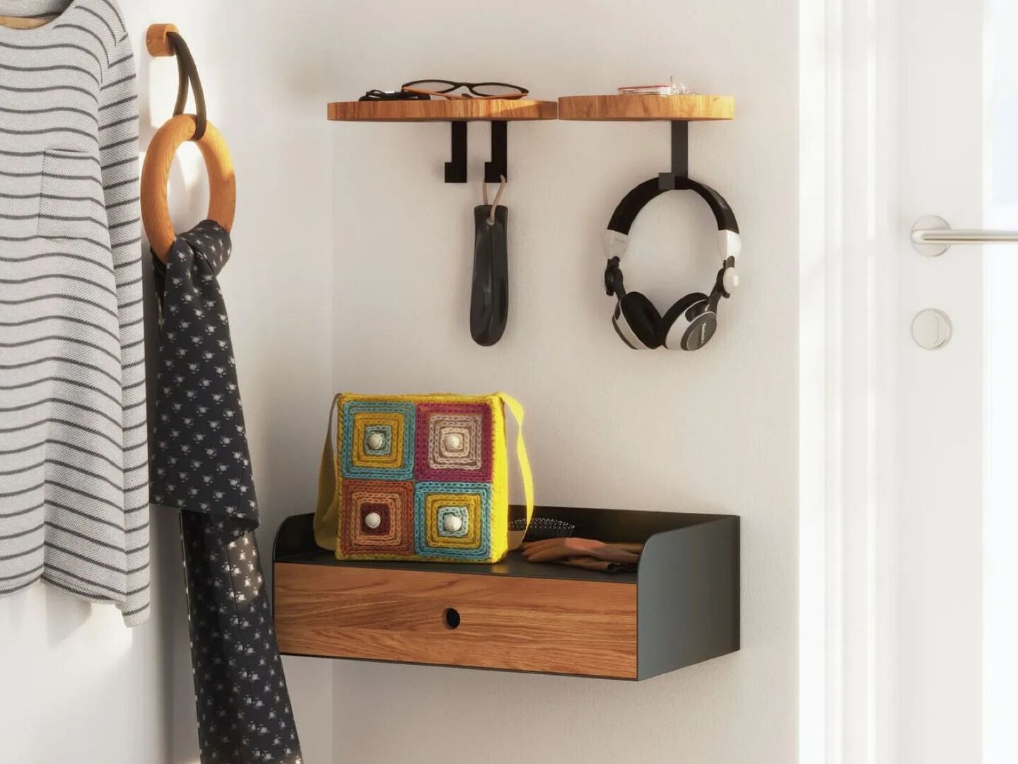 Wooden floating shelf and floating cabinet hanging on the wall next to a white door