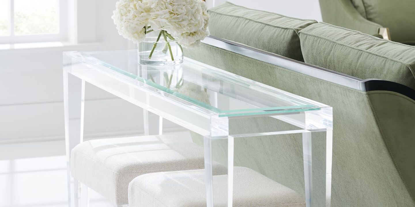 clear glass table with two plush chairs below and a vase with flowers on top clear glass table with two plush chairs below and a vase with flowers on top