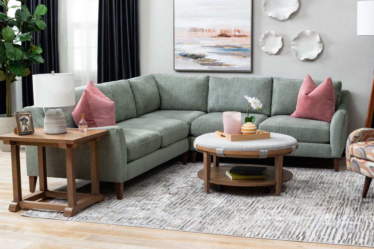 Light mint colored couch in a living room with light brown furniture