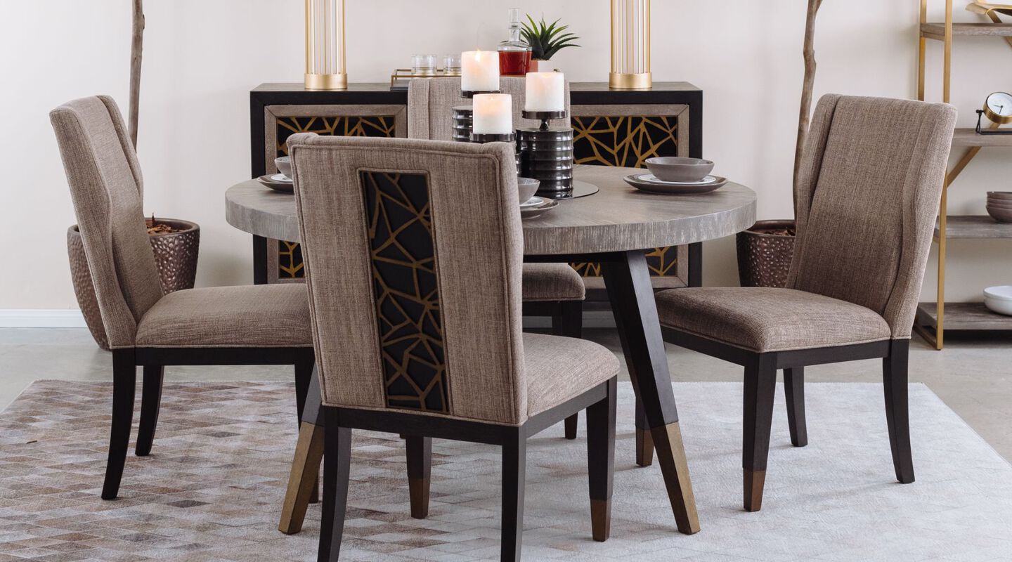 Dining room beige and black chairs, matching beige dining table, and a grey rug