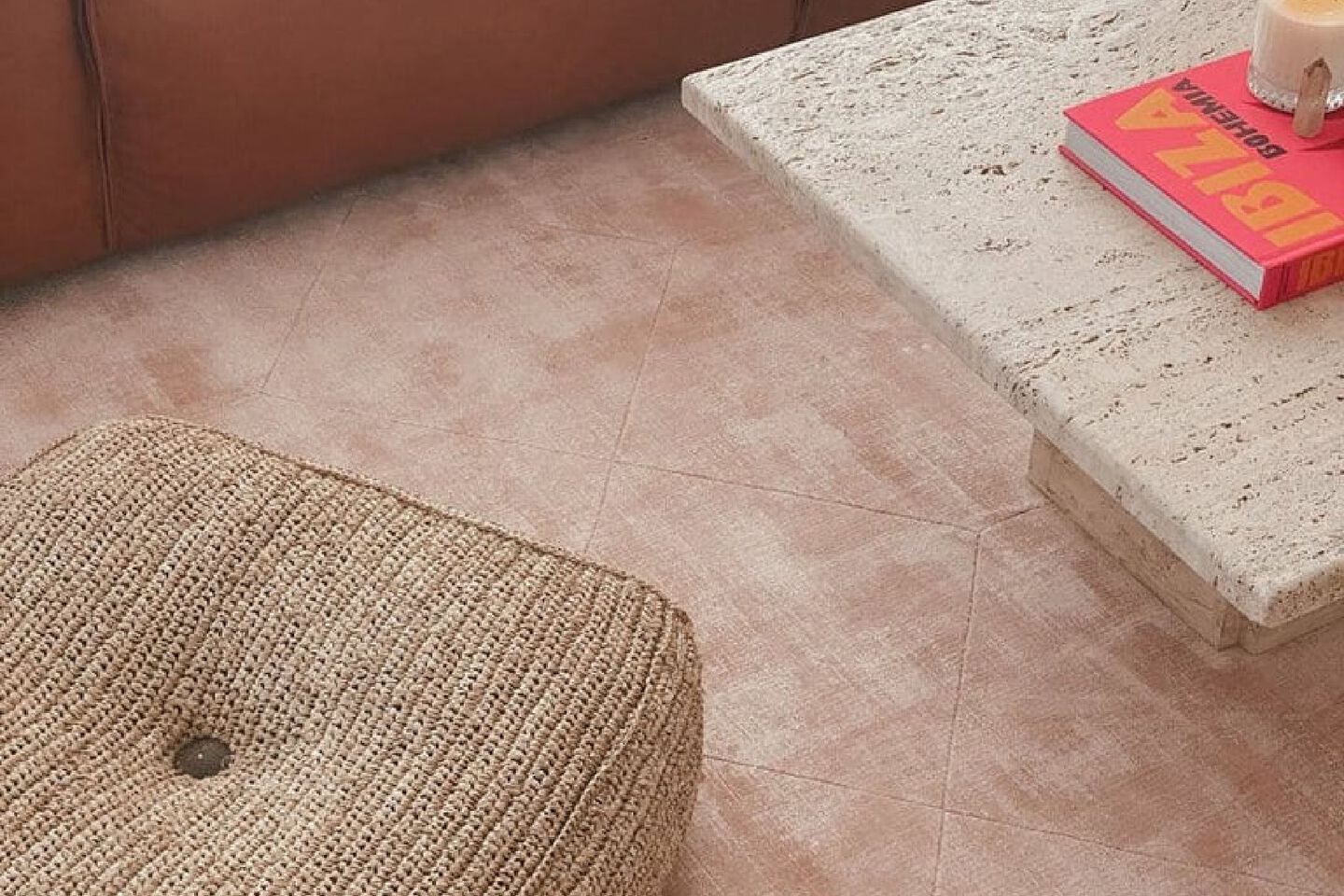 Closeup image of a peach-colored rug in a living room with a chair and coffee table
