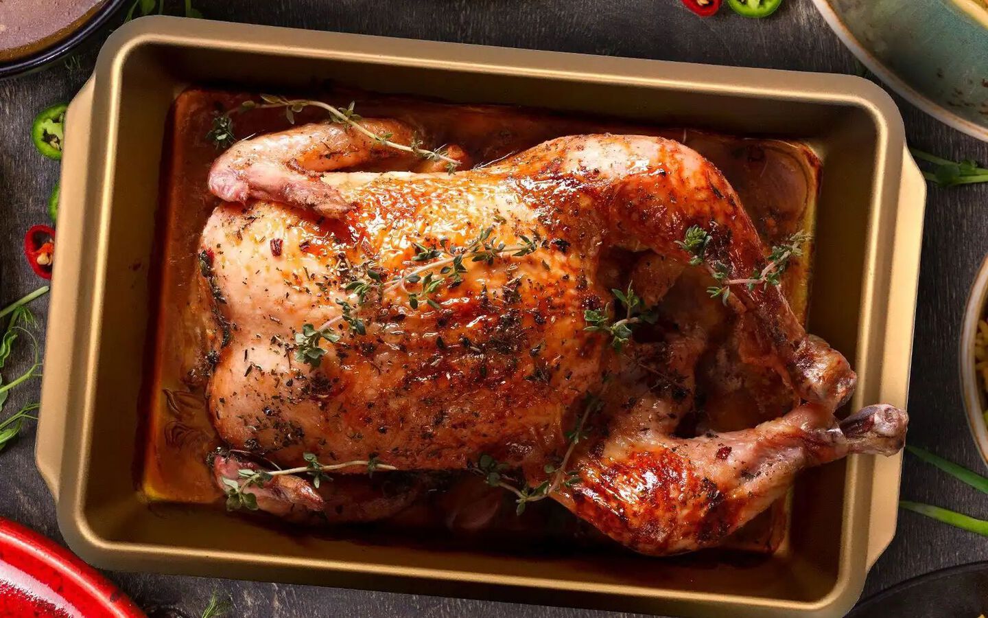 Aerial view of cooked Thanksgiving turkey in a gold pan