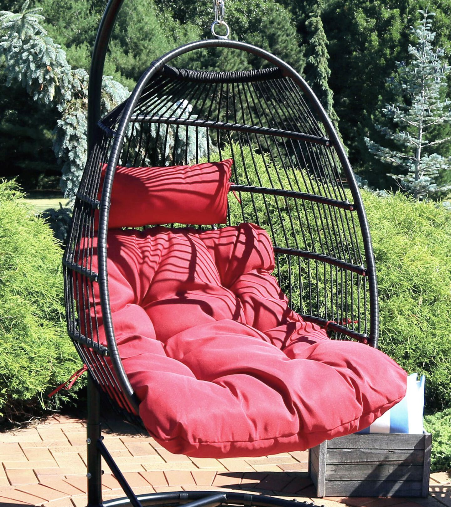 black hanging egg chair with a red cushion