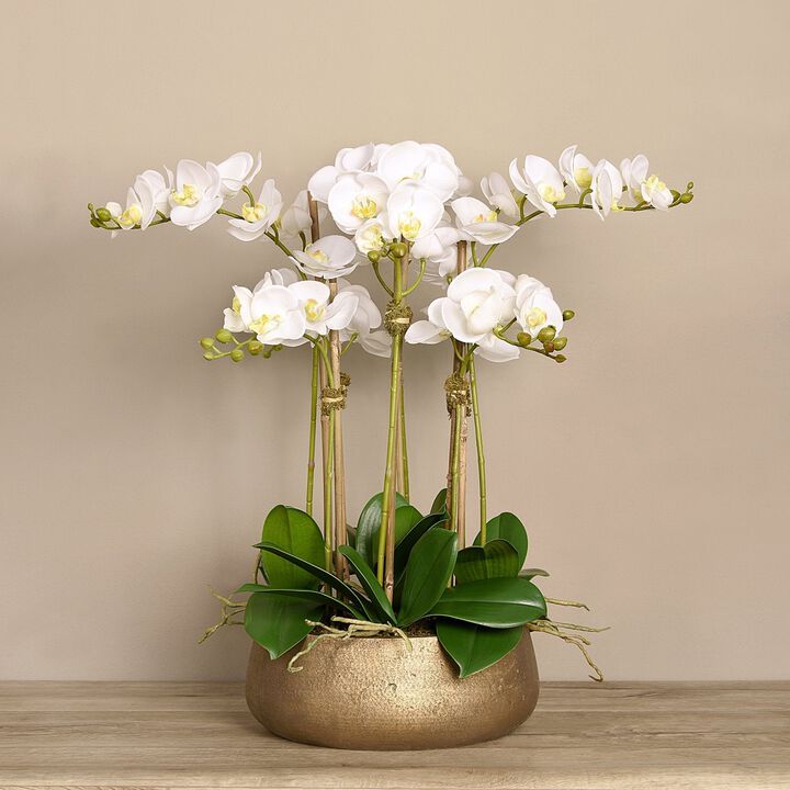 Faux white orchid arrangement in matte gold planter