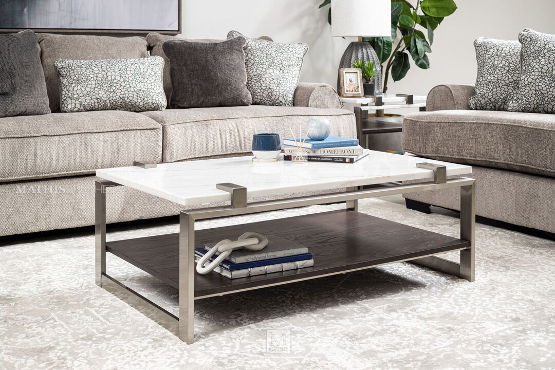 Marble top modern cocktail table with stainless steel frame andcontrasting wooden storage shelf.