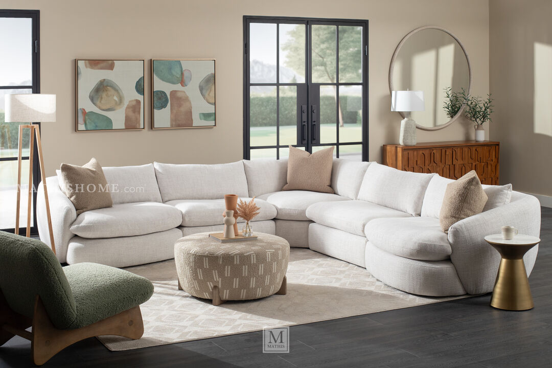 Spacious, all-white sofa with a rounded design, featuring deep, comfortable seating.