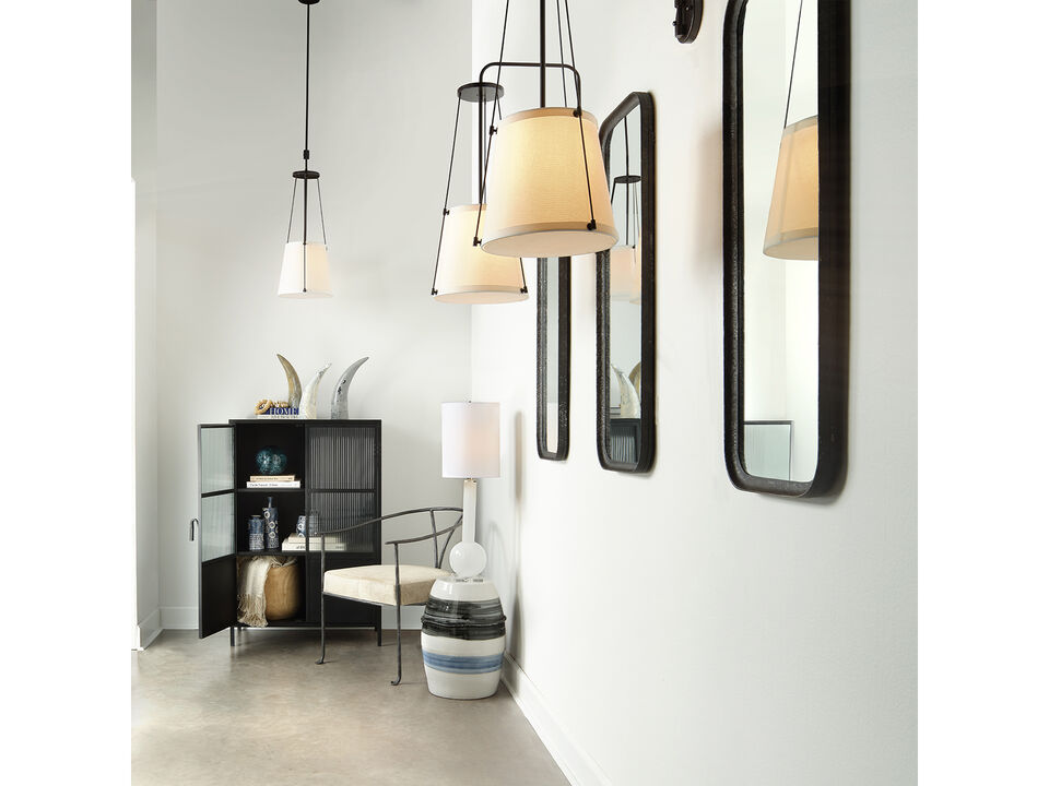 Hanging pendant light with an off-white drum shade and bronze metal framework.