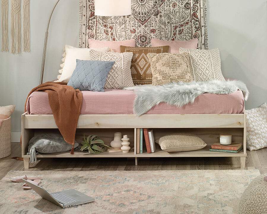 Pacific Maple® finish daybed is accented with tapered feet and soft chamfered edges